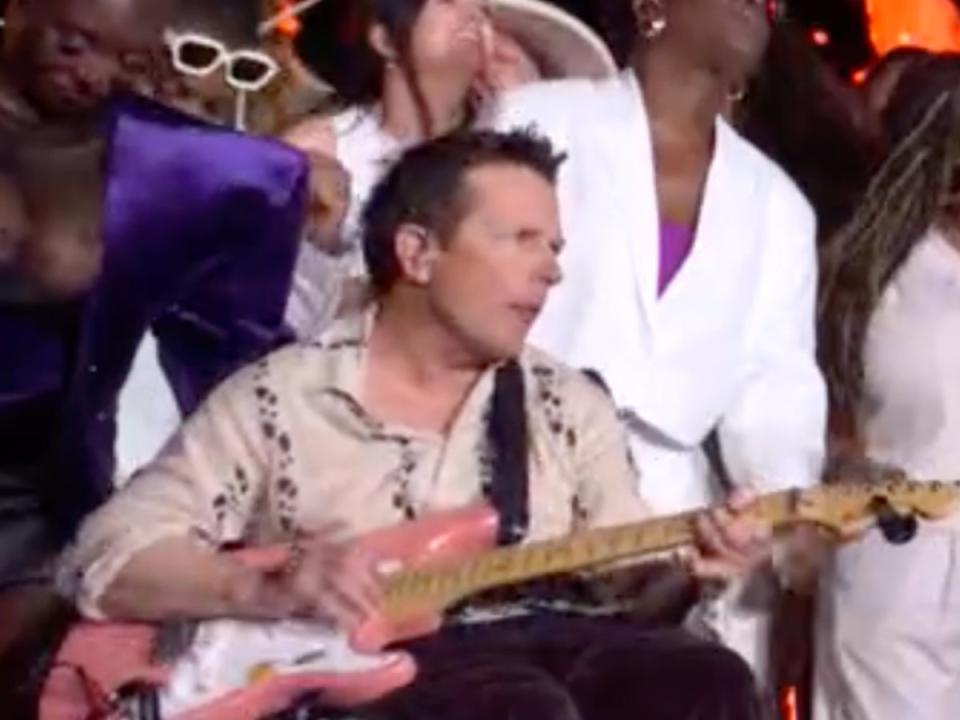 Michael J Fox plays guitar during Coldplay’s Glastonbury headline set (BBC)