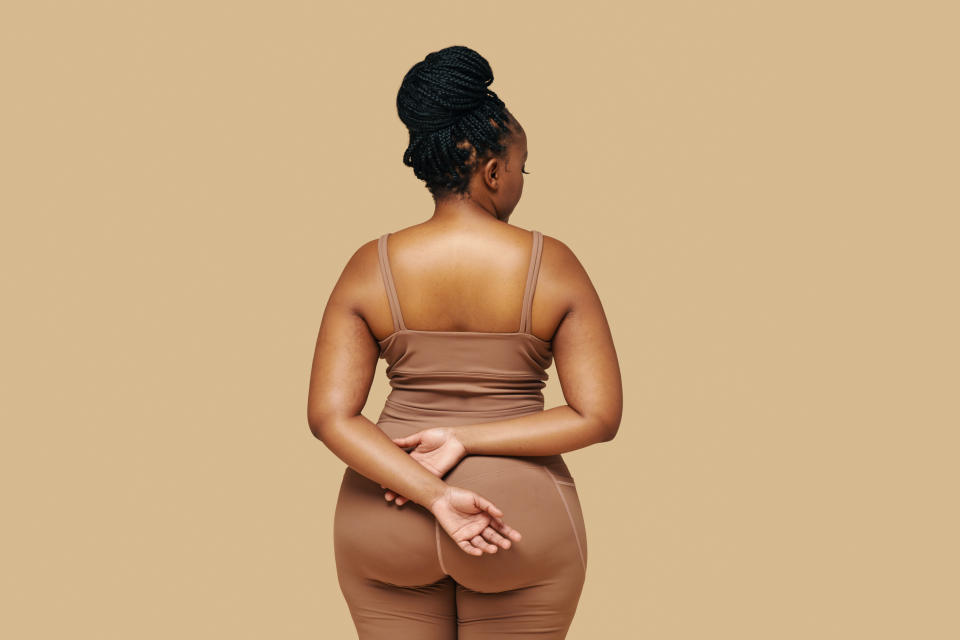 Studio portrait of curvy Black woman in sportswear, view from the back. Limiting exposure to unrealistic social media standards and focusing on health-oriented goals can foster a more positive self-view. (Getty Images)