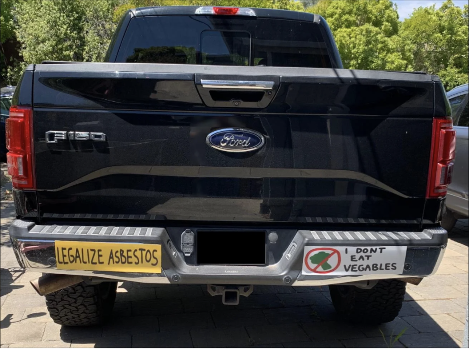 Ford F-150 truck with bumper stickers: "LEGALIZE ASBESTOS" and "DON'T EAT VEGABLES" with a crossed-out vegetable graphic