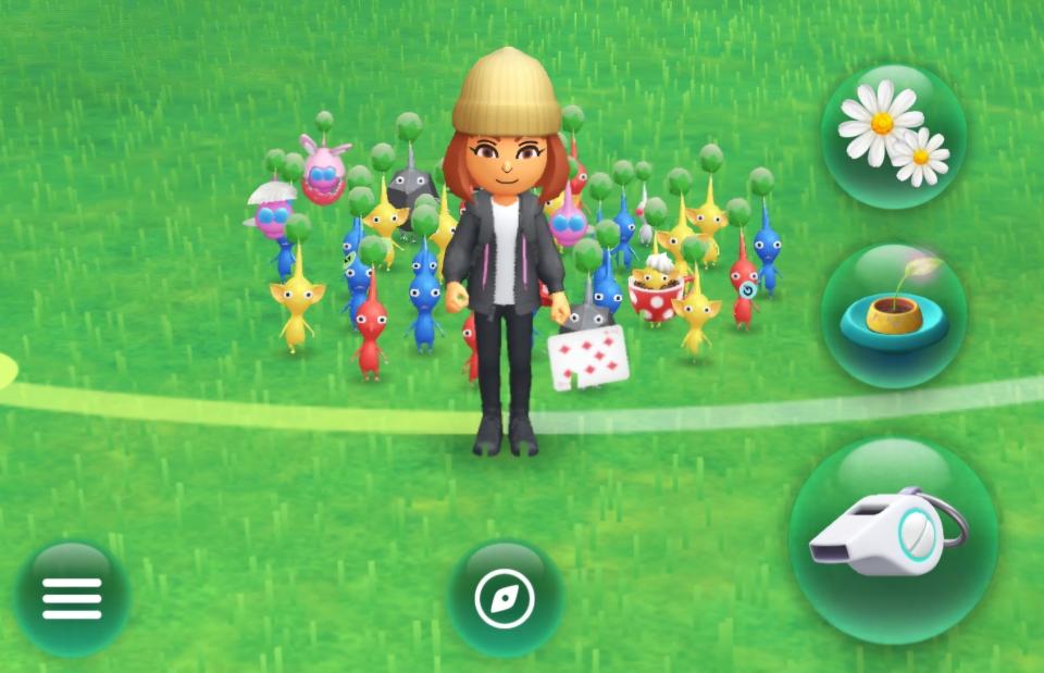 The author's Mii pictured in a screenshot from Pikmin Bloom, with a group of Pikmin standing around it