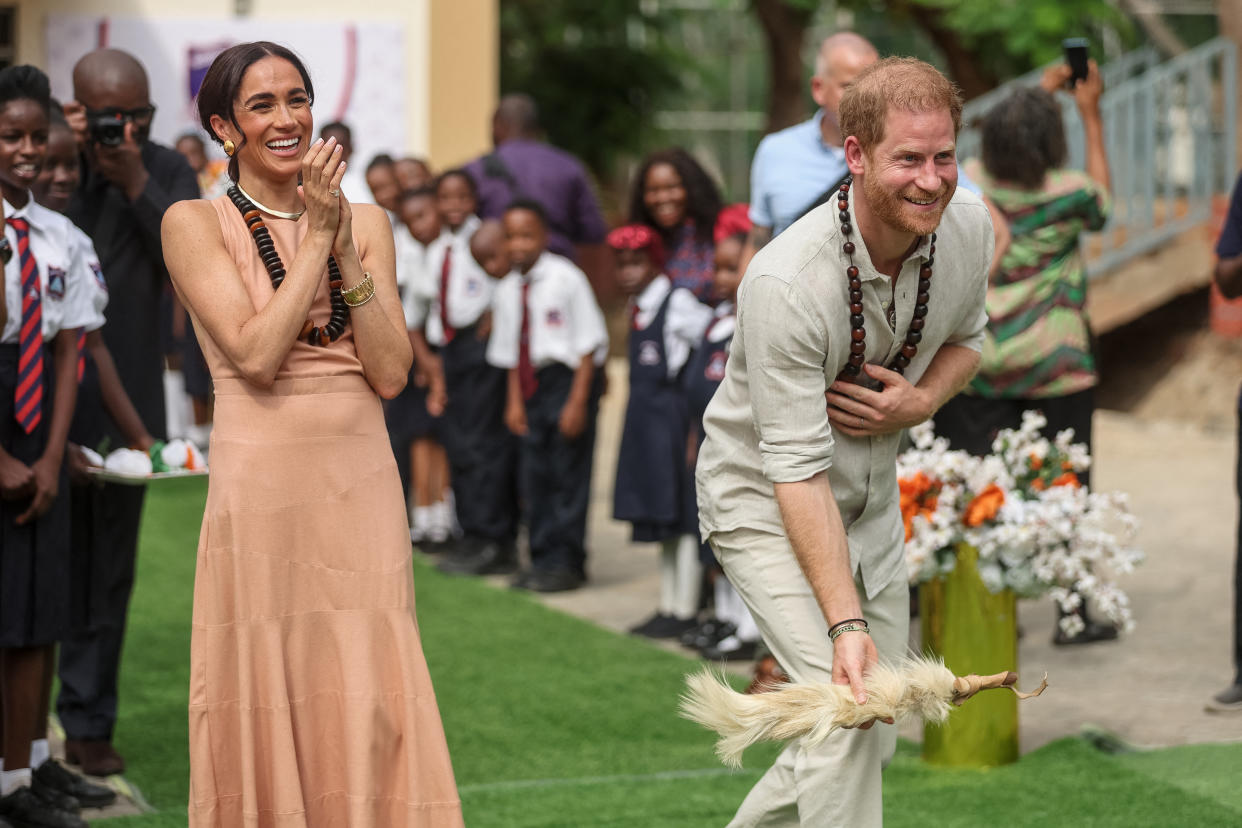 Prince Harry and Meghan Markle at the Lightway Academy in Abuja on May 10, 2024, as they visit Nigeria as part of celebrations of the Invictus Games anniversary. (Photo by Kola SULAIMON / AFP)