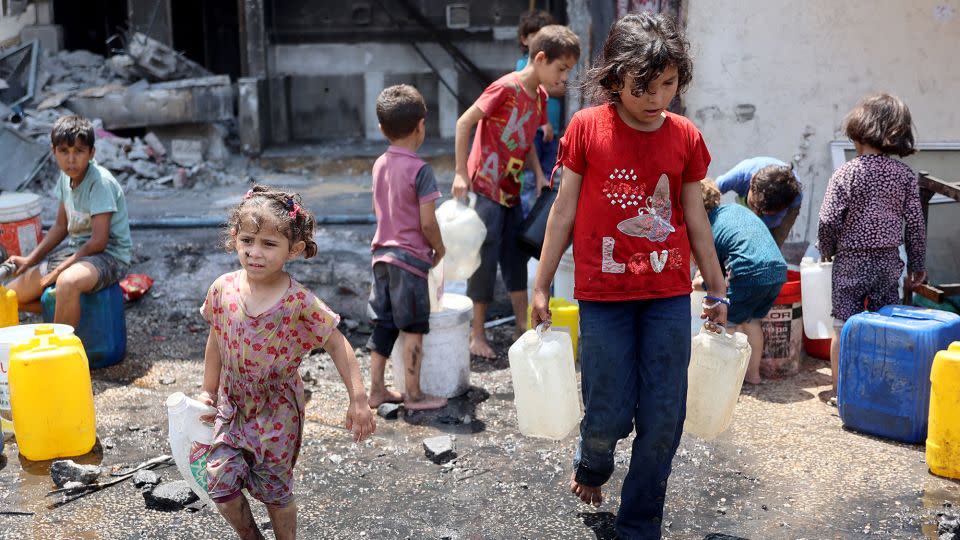 Palestinian children fill containers with water in Jabalya, in northern Gaza, on June 3. The UN says at least 67% of water and sanitation facilities in the ravaged territory have been destroyed or damaged. - Omar Al Qatta/AFP/Getty Images