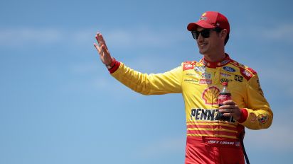 Getty Images - LEBANON, TENNESSEE - JUNE 30: Joey Logano, driver of the #22 Shell Pennzoil Ford, waves to fans as he walks onstage during driver intros prior to the NASCAR Cup Series Ally 400 at Nashville Superspeedway on June 30, 2024 in Lebanon, Tennessee. (Photo by James Gilbert/Getty Images)