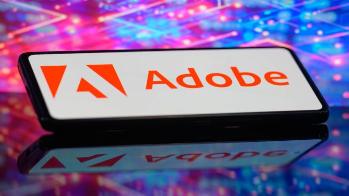 The Adobe logo is being displayed on a smartphone in this photo illustration in Brussels, Belgium, on June 10, 2024. (Photo Illustration by Jonathan Raa/NurPhoto via Getty Images)