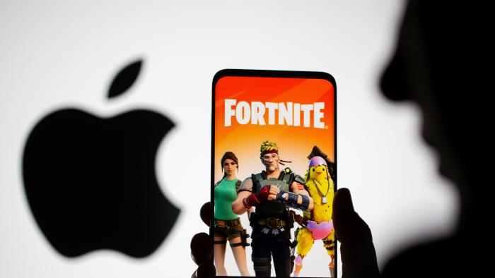 Fortnite game graphic is displayed on a smartphone in front of Apple logo in this illustration taken May 2, 2021. REUTERS/Dado Ruvic/Illustration