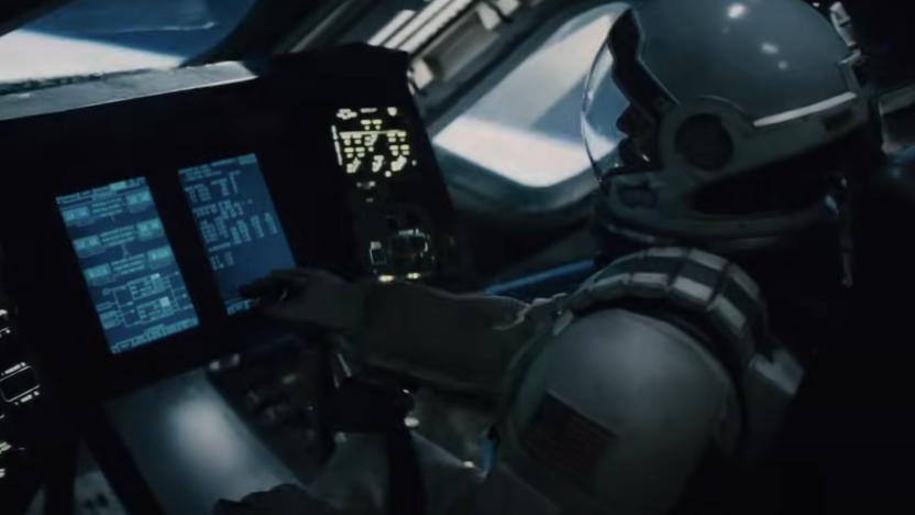 A still from the trailer for the movie Interstellar showing an astronaut sitting at a control panel in a space ship
