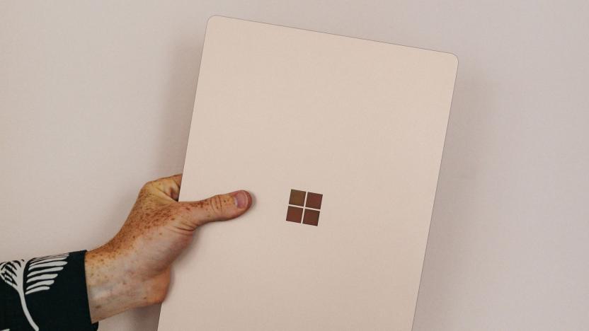 A hand holding a Microsoft device. 