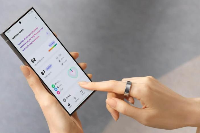 A person accesses their health data on a Samsung smartphone while wearing a Samsung Galaxy ring.