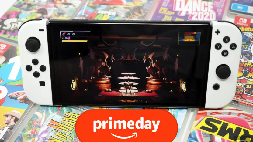 A white Nintendo Switch OLED sits on a stack of Nintendo Switch game cases, with the game Metroid Dread displayed on screen.