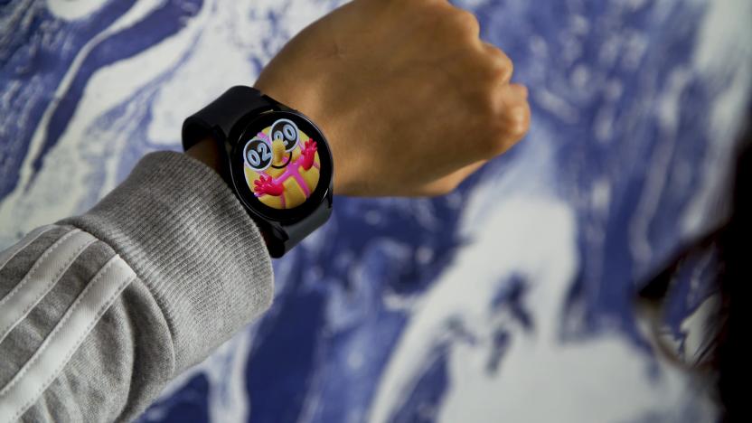 A person’s left wrist wearing the Samsung Galaxy Watch. Blue and white swirled background (blurred).