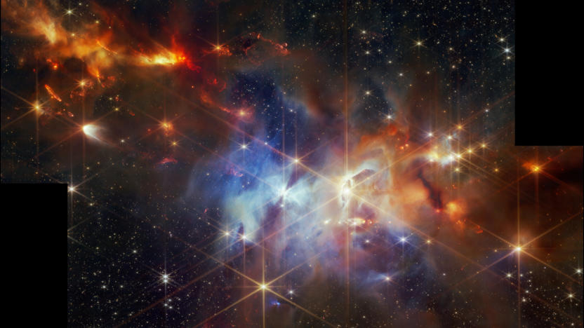 Space image, showing forming stars in the Serpens Nebula. Red, orange, blue, black, diffraction spikes.