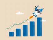 Businessman riding rocket on growth bar graph or rising up revenue chart