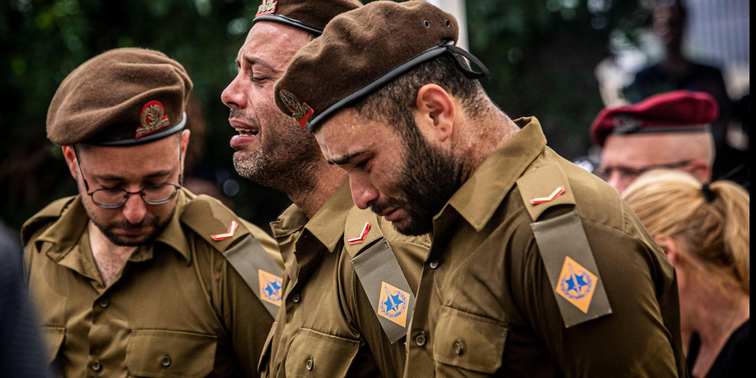 Members of the Israel Defense Forces weep at the funeral of a comrade.