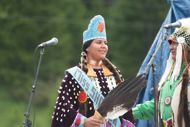 <p>Miss Shoshnone-Bannock Queen Develynn Hall takes the stage during a naming ceremony for a white buffalo calf at the headquarters of the Buffalo Field Campaign. The buffalo has not been seen for weeks after birth.  </p>
